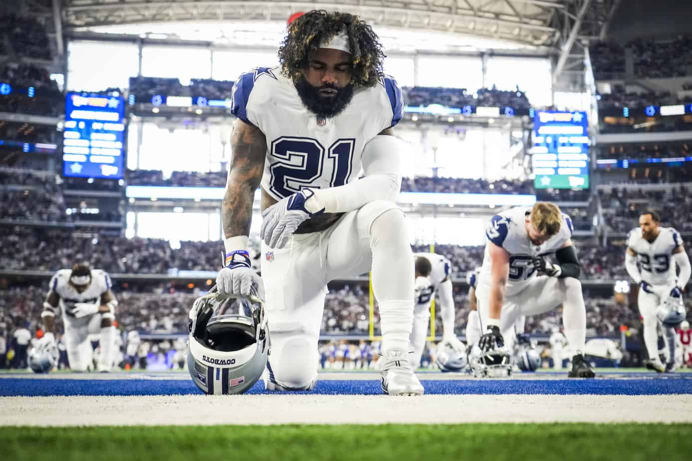 Dallas Cowboys running back Ezekiel Elliott kneels in the end zone before an NFL football game against the Arizona Cardinals at AT&T Stadium on Sunday, Jan. 2, 2022, in Arlington.